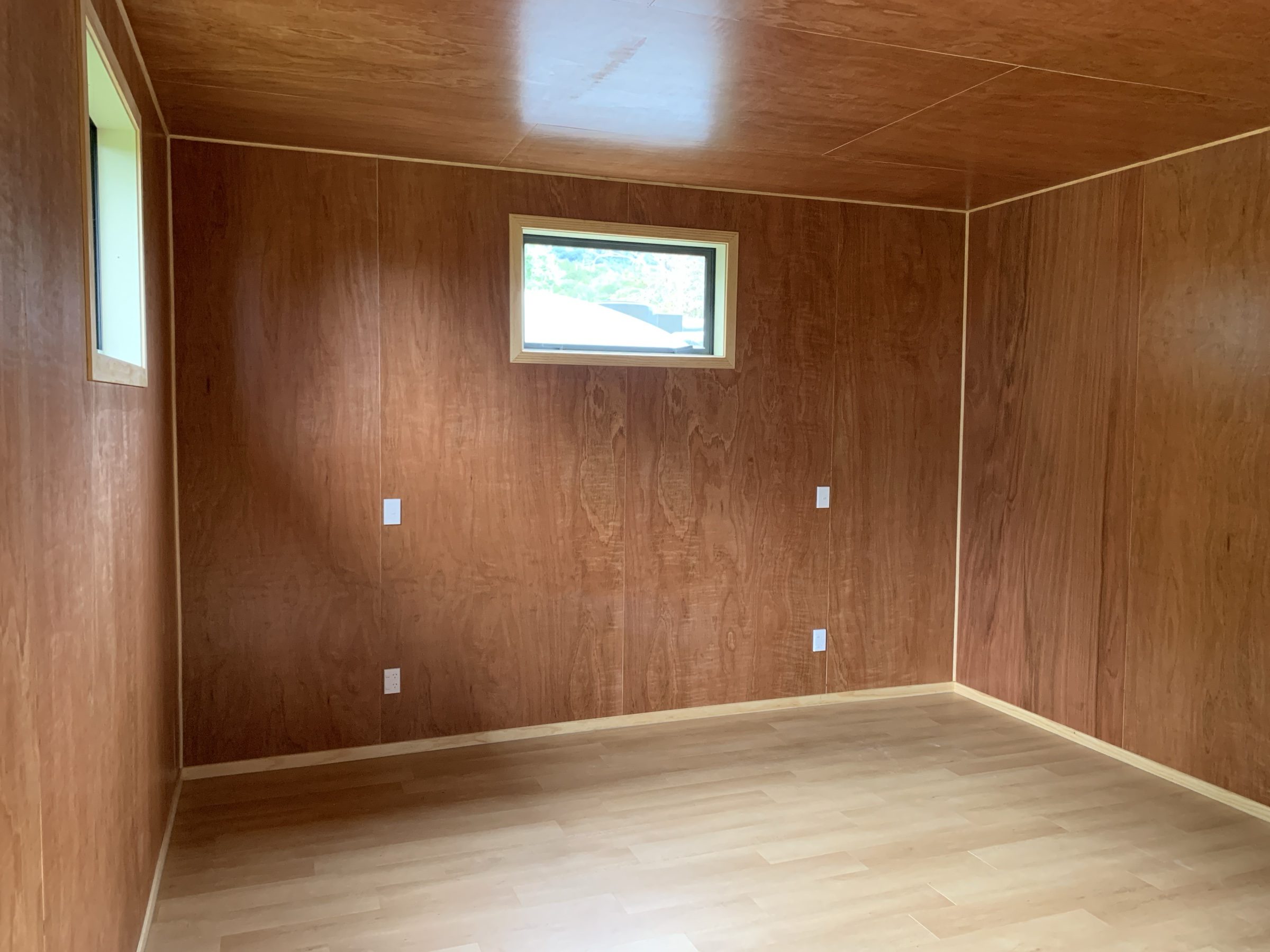 Timber-lined room with window, finished interior